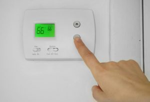 adjusting-thermostat-to-66-degrees