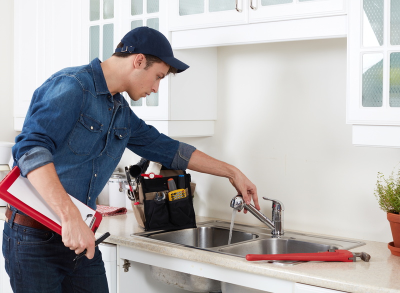 plumber-at-kitchen-sink